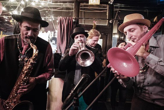 Sax, trumpet and trombone playing live