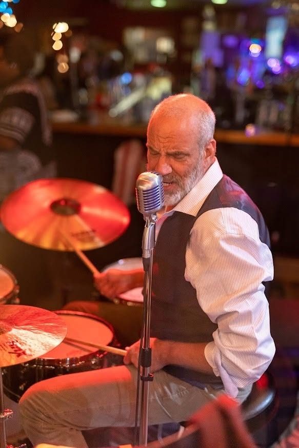 John Jay Myers singing from behind the drum kit